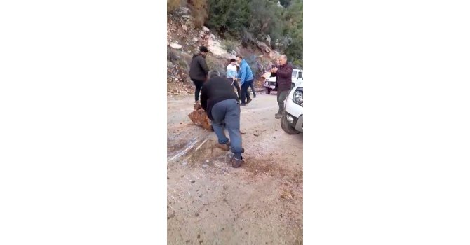 Yola düşen kayaları iple araca bağlayıp çektiler